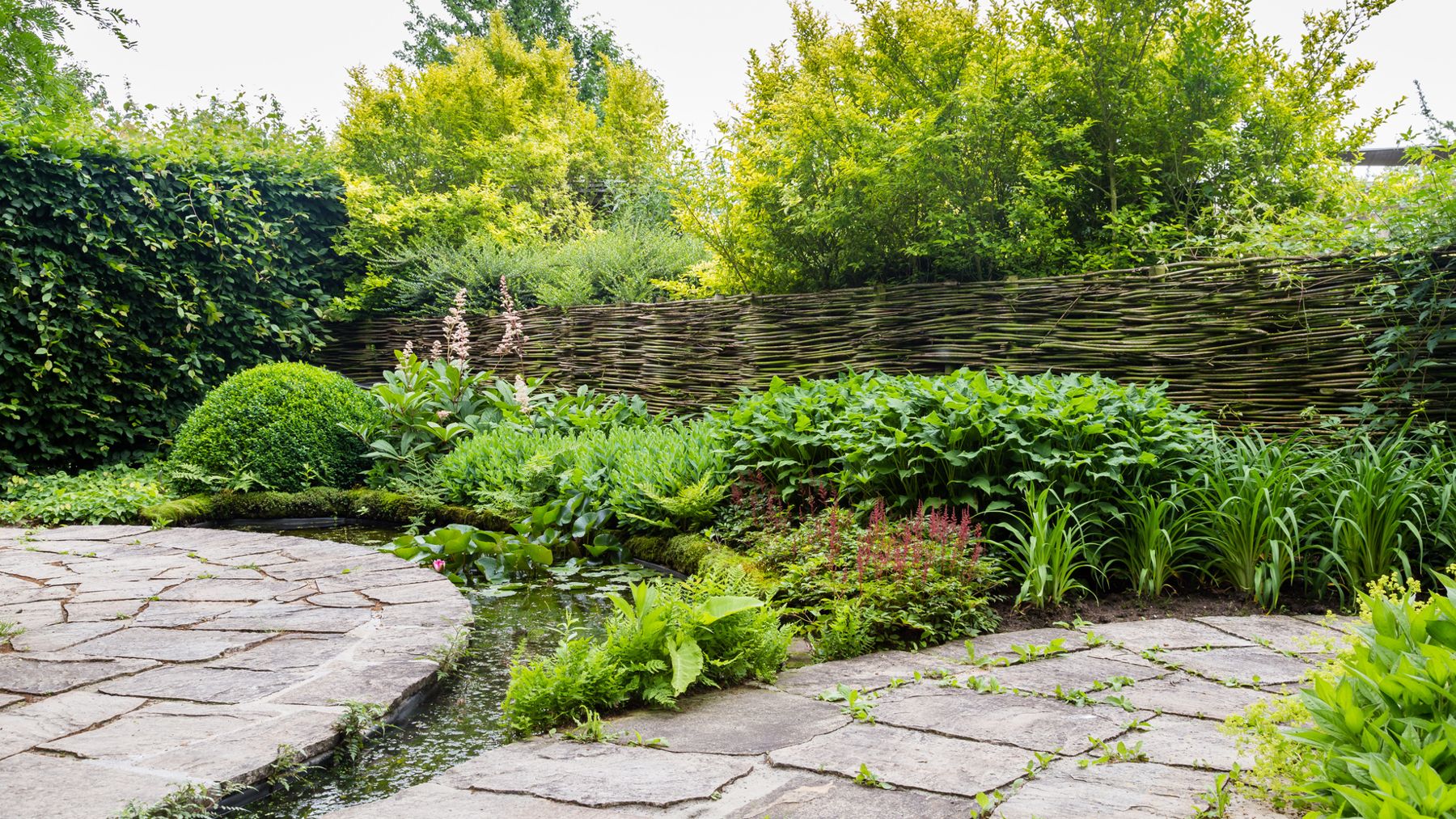 Curved flagstone path beside garden plantings