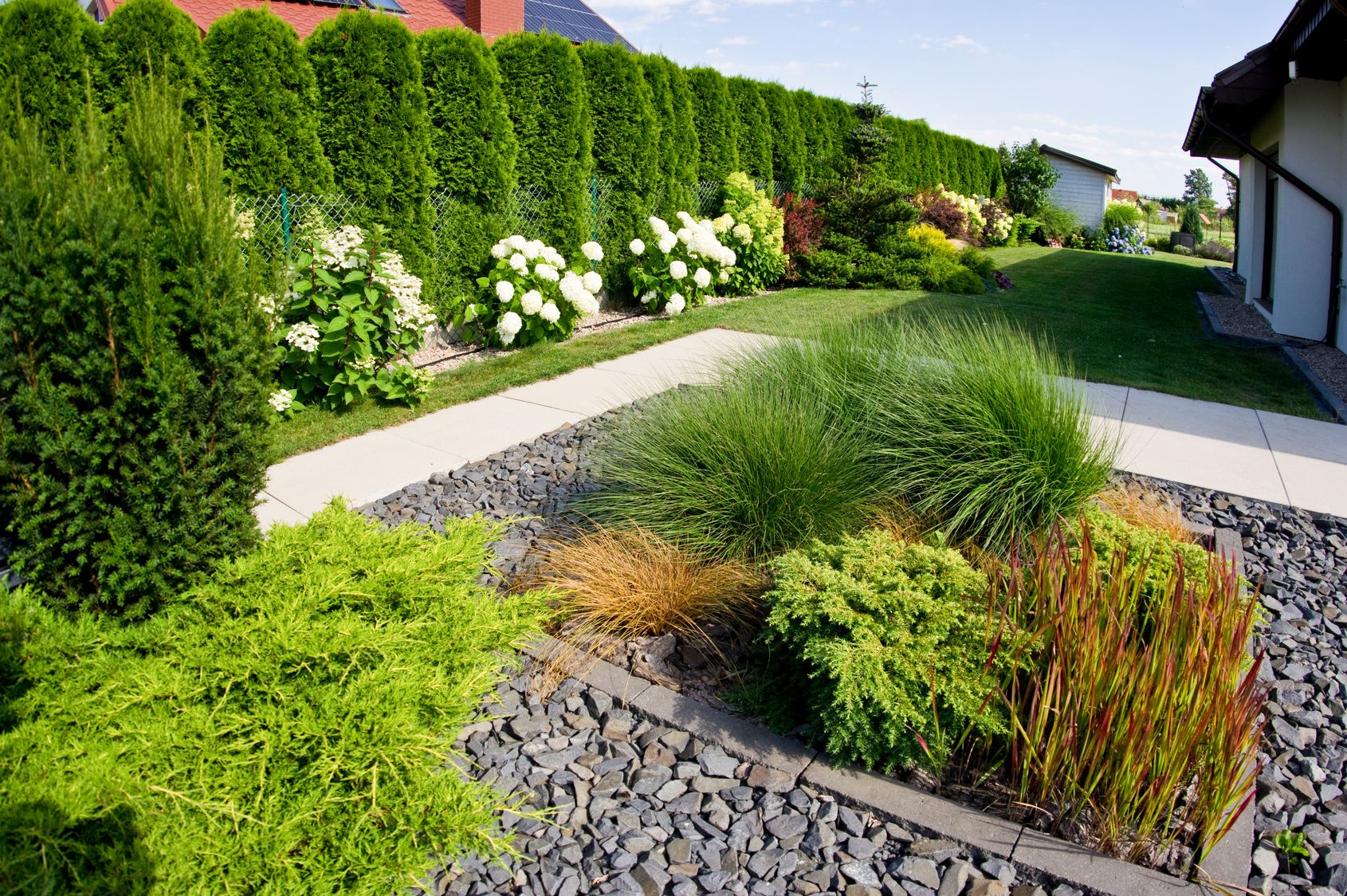 Modern front yard with ornamental grasses and rock mulch